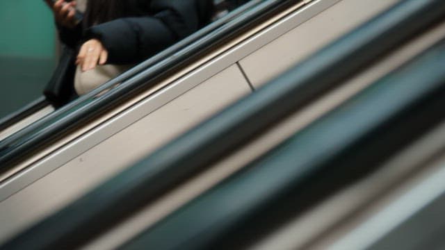 People on an escalator in a subway station