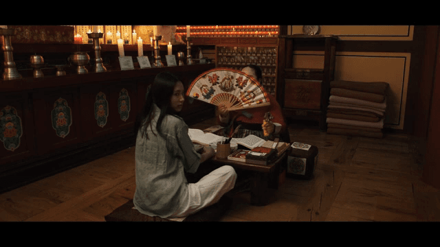 Shaman holding a fan and telling fortunes