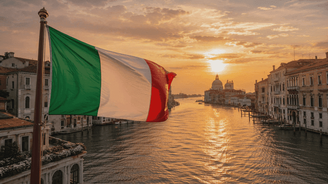 Italian flag waving over a canal at sunset