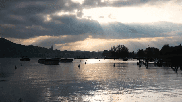 Tranquil lake with boats in sun