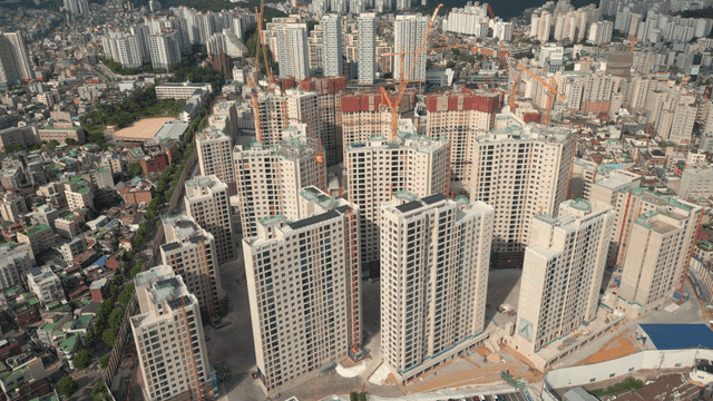 High-rise apartment construction site in bustling city