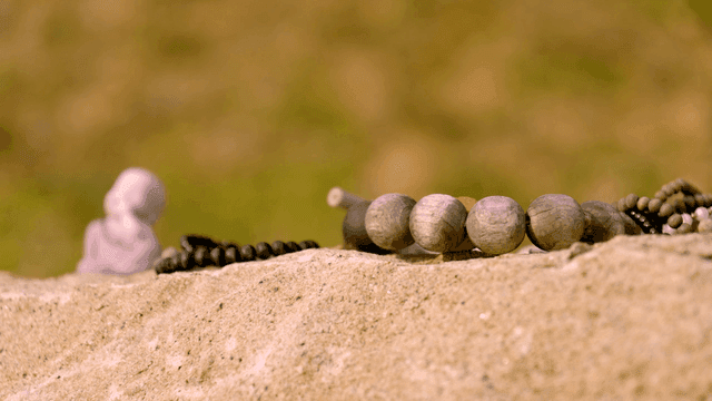 Small Buddha statue on rock
