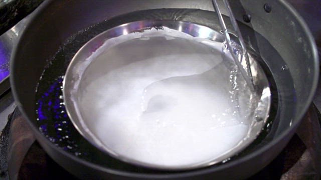 Tray with starch batter placed on top of hot water