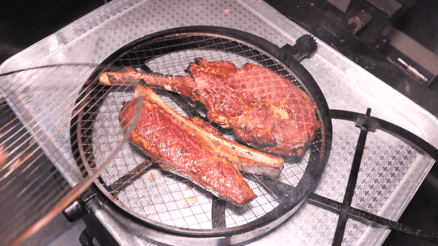 Grilled Tomahawk Steak Sizzling on BBQ