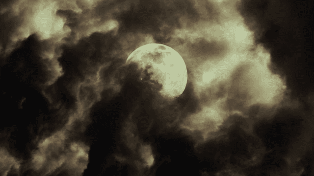 Moon partially obscured by clouds