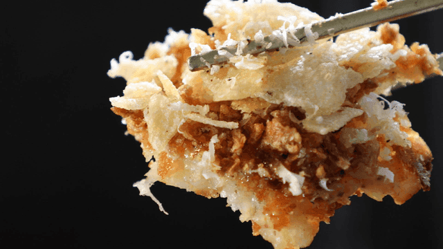 Chopsticks picking up crispy fried food