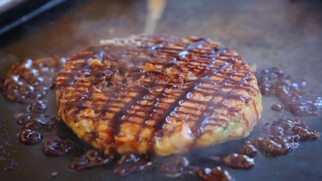 Okonomiyaki Cooked Deliciously on an Iron Plate