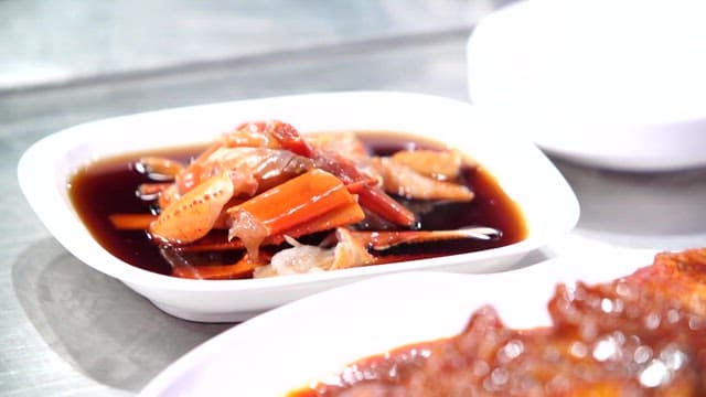Korean food on the table with soy sauce marinated crab and spicy assorted braised fish