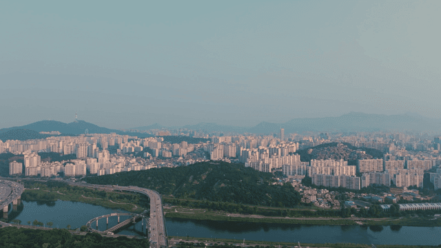 Wide cityscape with river and mountains