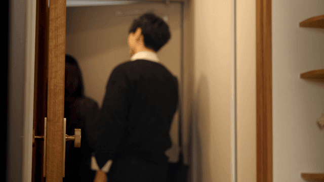 Smiling couple stepping out of cozy home entrance