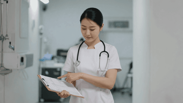 Nurse holding clipboard at hospital