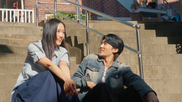 Couple sitting on outdoor steps in sunlight