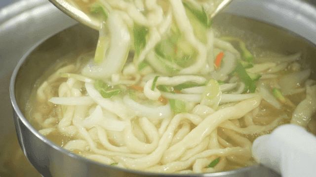 Hand-cut noodles added to pot