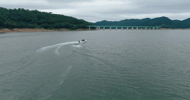 People water skiing on a large lake