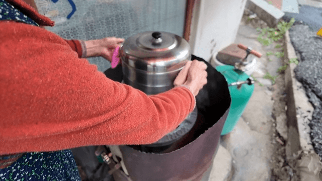 Grandmother carrying a hot steamer