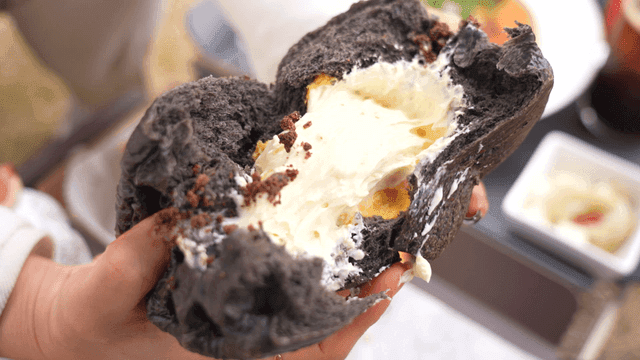 Person who breaks cream bun in half