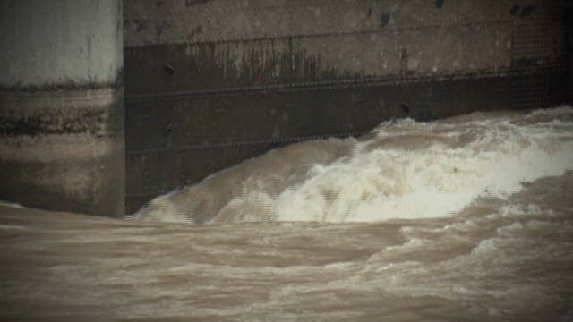 Water gushing powerfully through a dam