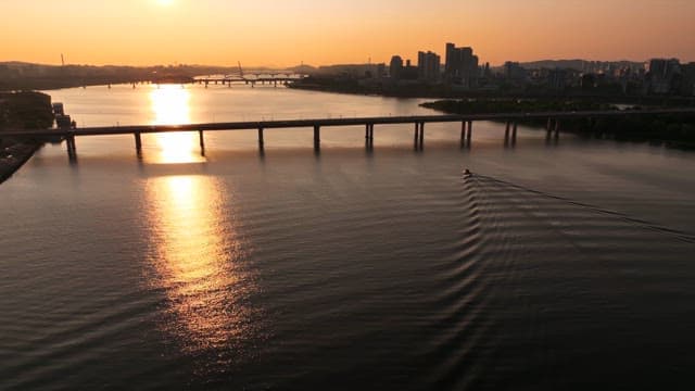 Sunset over a tranquil river with city background