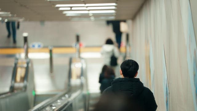 People on an escalator in a subway station