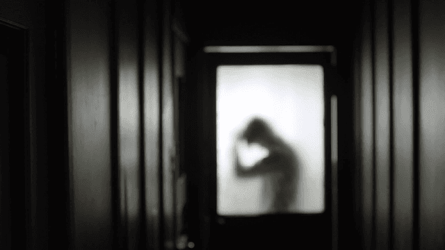 Silhouette of a person through frosted glass