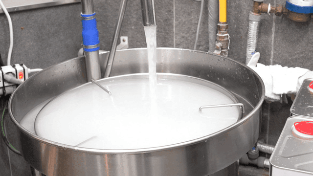 White rice washed in stainless steel basin