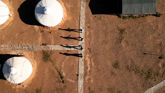 People walking near traditional yurts