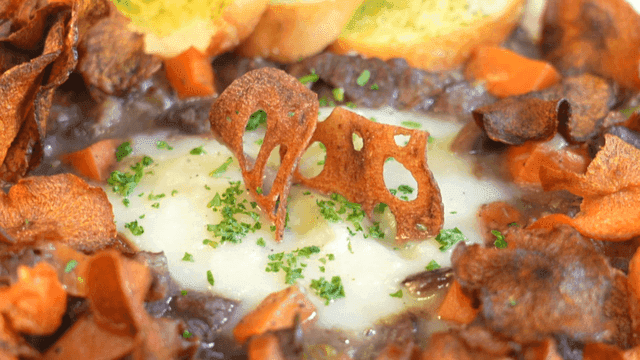 Beef Bourguignon topped with plenty of bread and chips
