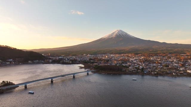 Mount Fuji and a lakeside city at sunrise