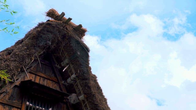 Thatched Roof Traditional House against Blue Sky