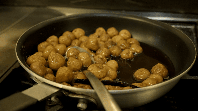 Figs simmering in a pan with syrup