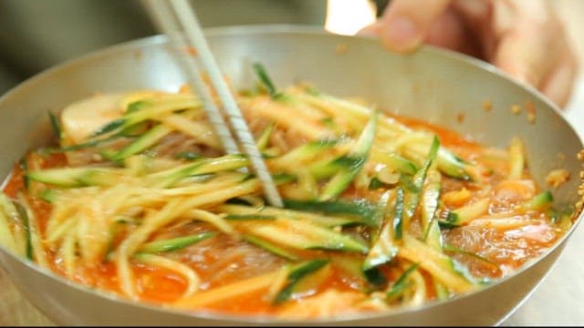 젓가락으로 냉면을 휘젓는 모습