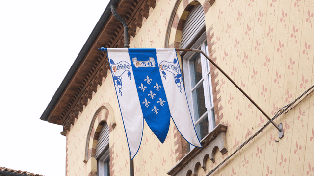 Decorative flags on exterior walls of European buildings