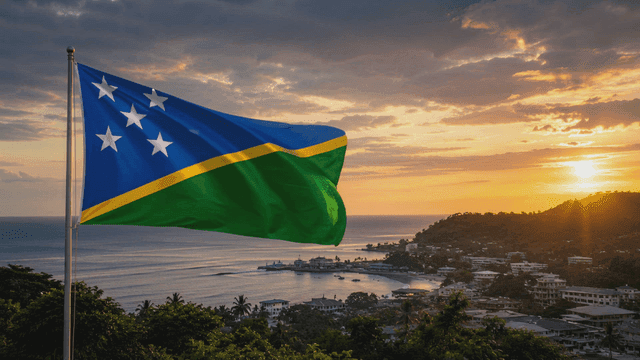 Solomon Islands flag fluttering on coast at sunset