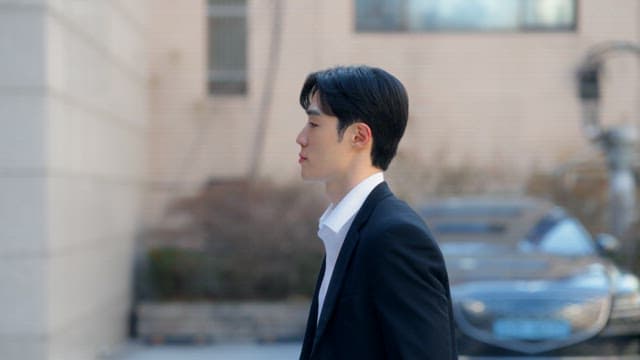 Man in a suit entering a building