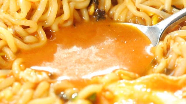 A spoonful of spicy ramen broth