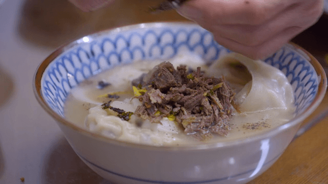 Korean sliced rice cake and mandu soup with beef with beef and seaweed