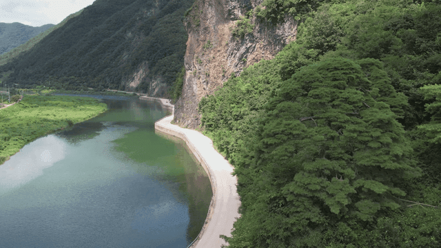 Tranquil river flowing along blue cliffs