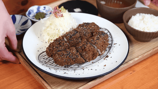 Plate with pork cutlet, rice, and salad