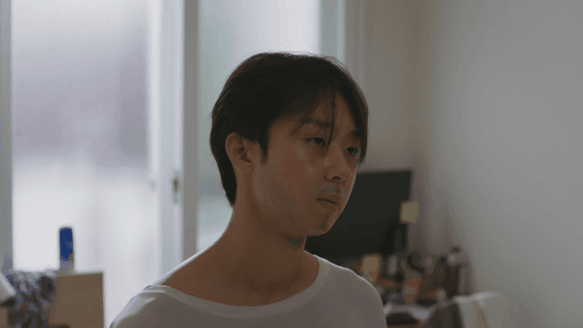 Man in a room looking contemplative