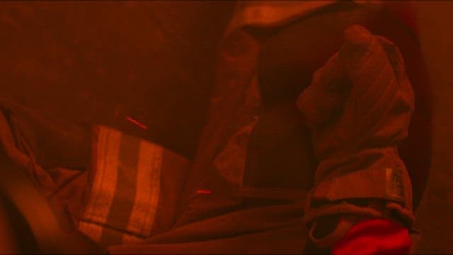 화재 현장에서 장갑을 낀 채 양초를 손에 쥔 소방관