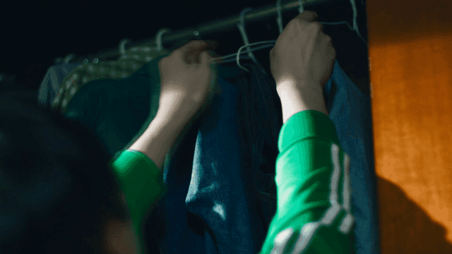 Back view of person organizing clothes in closet