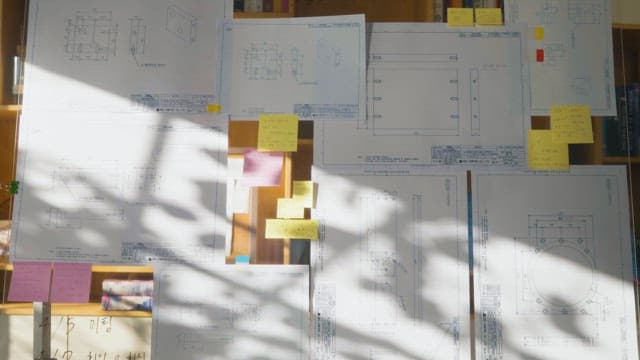 Engineering blueprints illuminated by sunlight