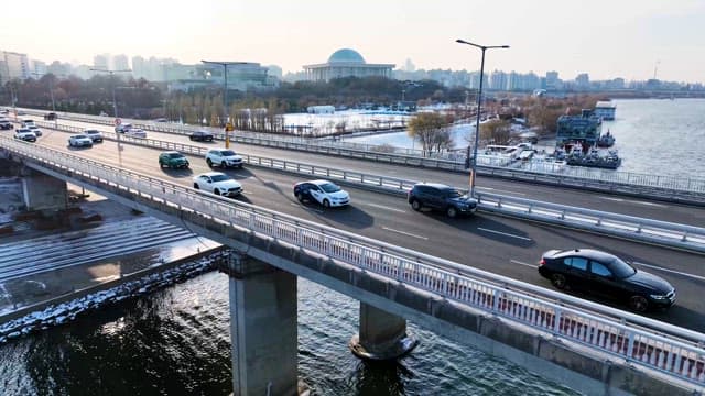 Aerial View of Traffic on River Bridge