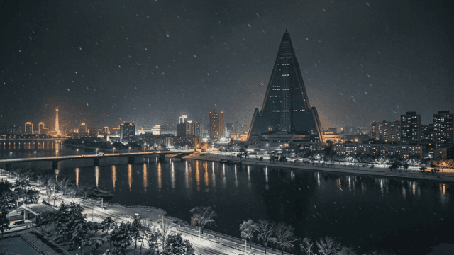 Snowy night view of North Korean city overlooking river