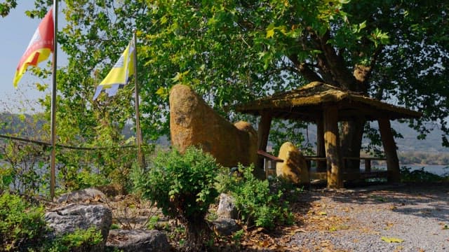 Rock tower surrounded by trees and greenery