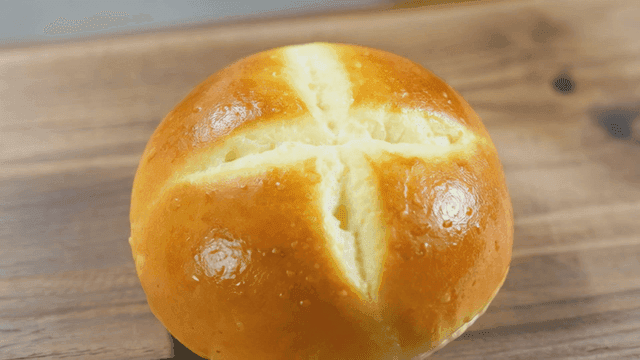 Freshly baked round bread on wooden table