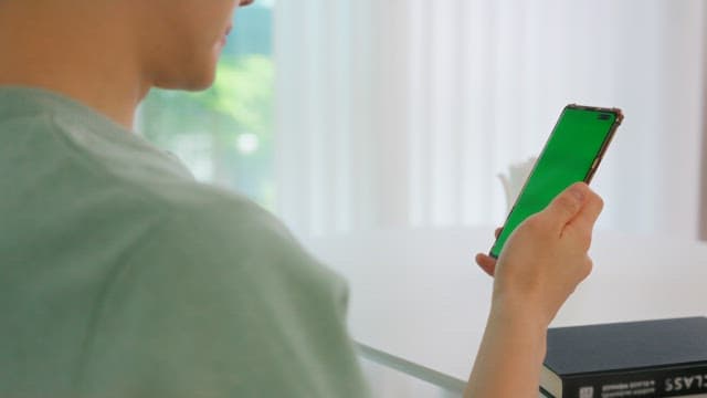 Person Using Smartphone Indoors