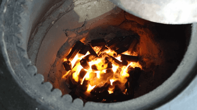 Charcoal burning in a traditional stove