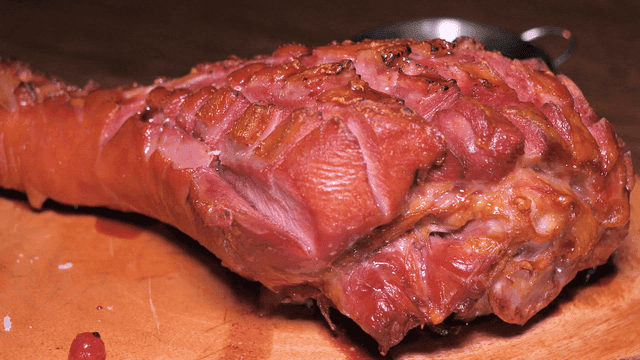 Roasted turkey legs on wooden cutting board