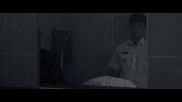Two students in a dimly lit bathroom